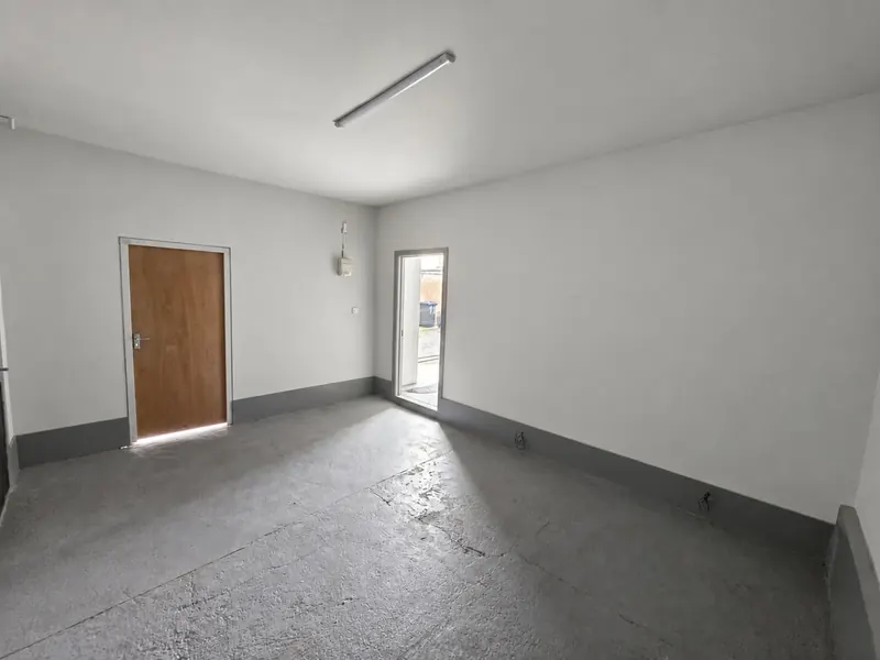 Empty storage unit in Blackpool with ceiling lighting, power sockets and painted walls